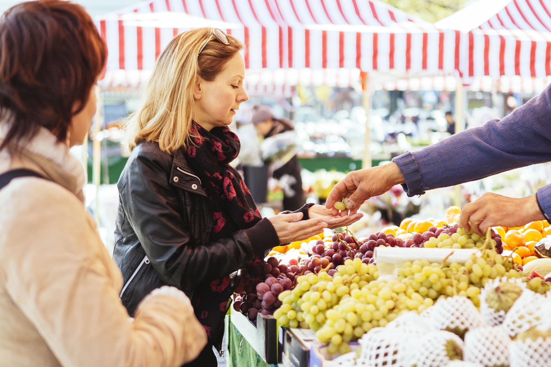 mature woman buying grapes at market stall 2021 08 29 00 50 39 utc min